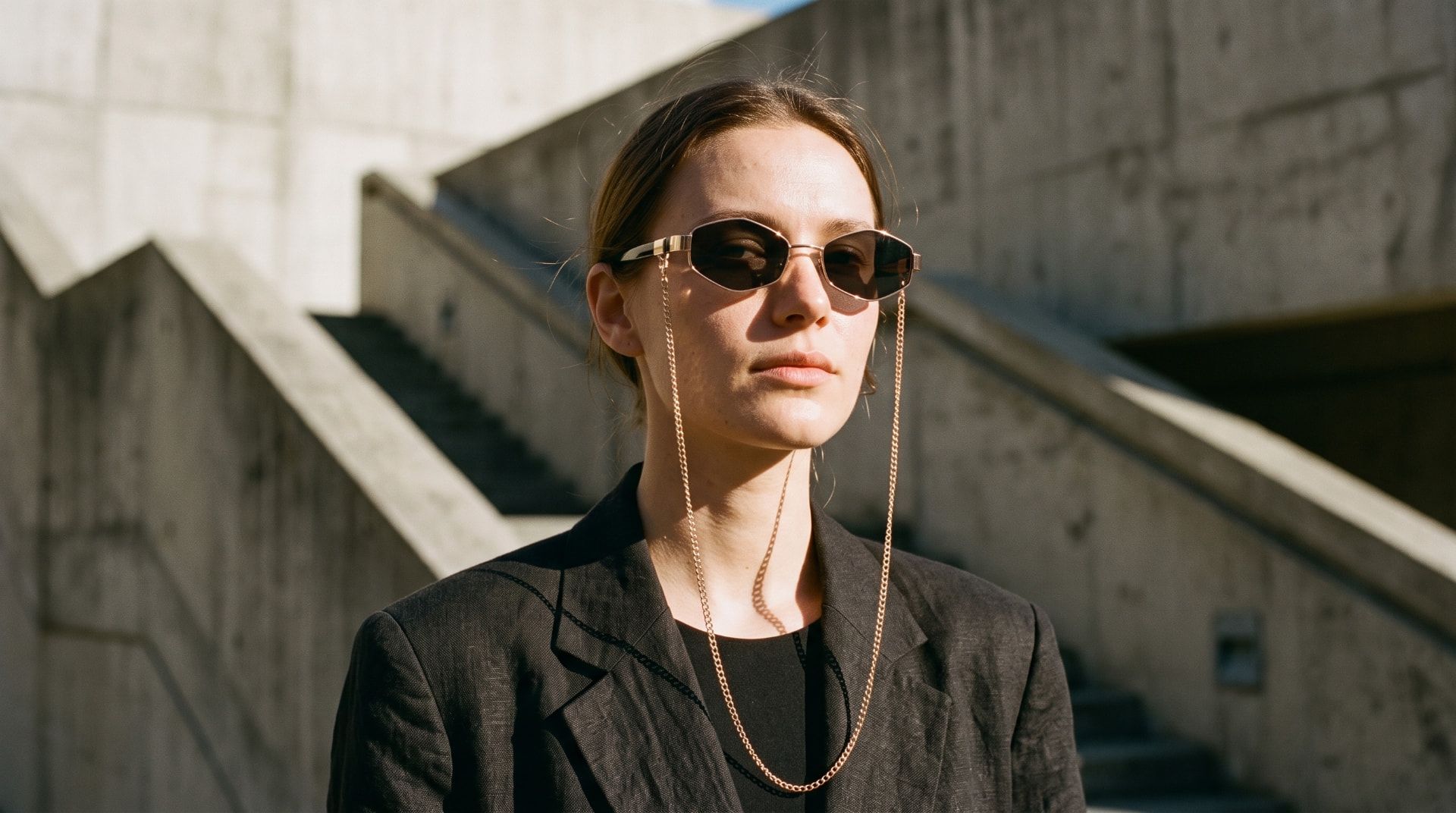 Sunkillerz Urban WarriorZ banner — model in gold chain sunglasses against concrete architecture